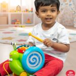Toddler playing with Funskool Giggles Musical Snail toy indoors